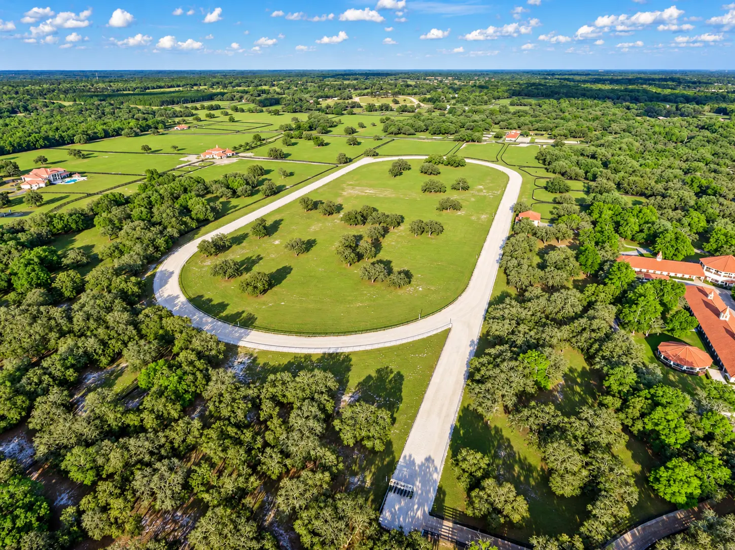 Aerial view of the training track, starting gate and surrounding paddocks in daylight