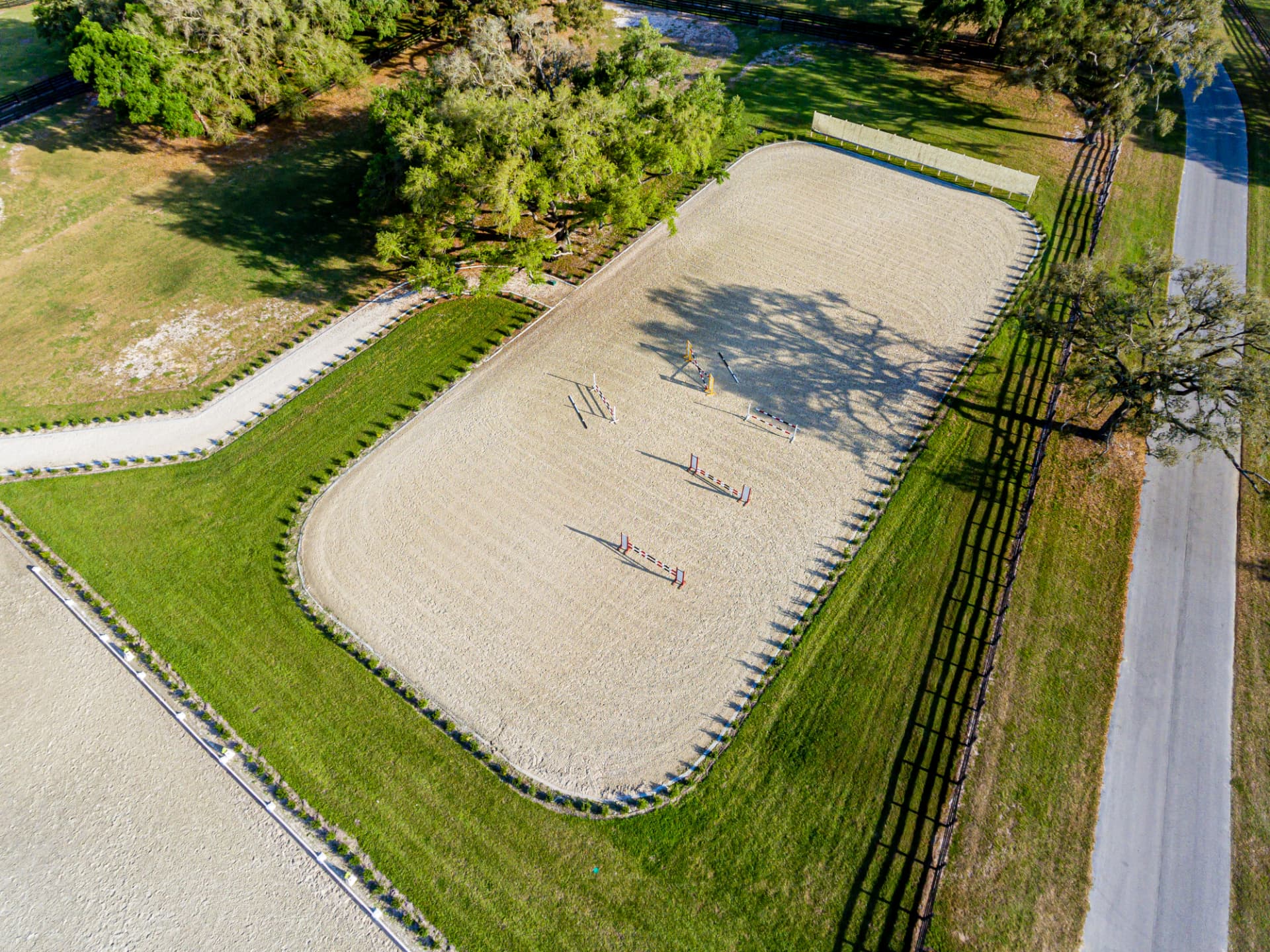 Overhead photo of the arena with jumps laid out on fresh footing