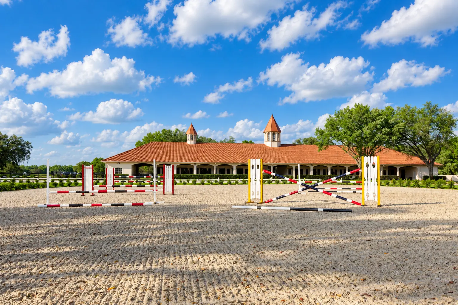 The sand jumping arena with numbered fences set on fresh footing